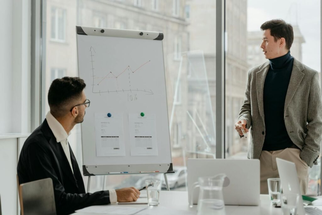 Professionals discussing a business chart in a modern office.