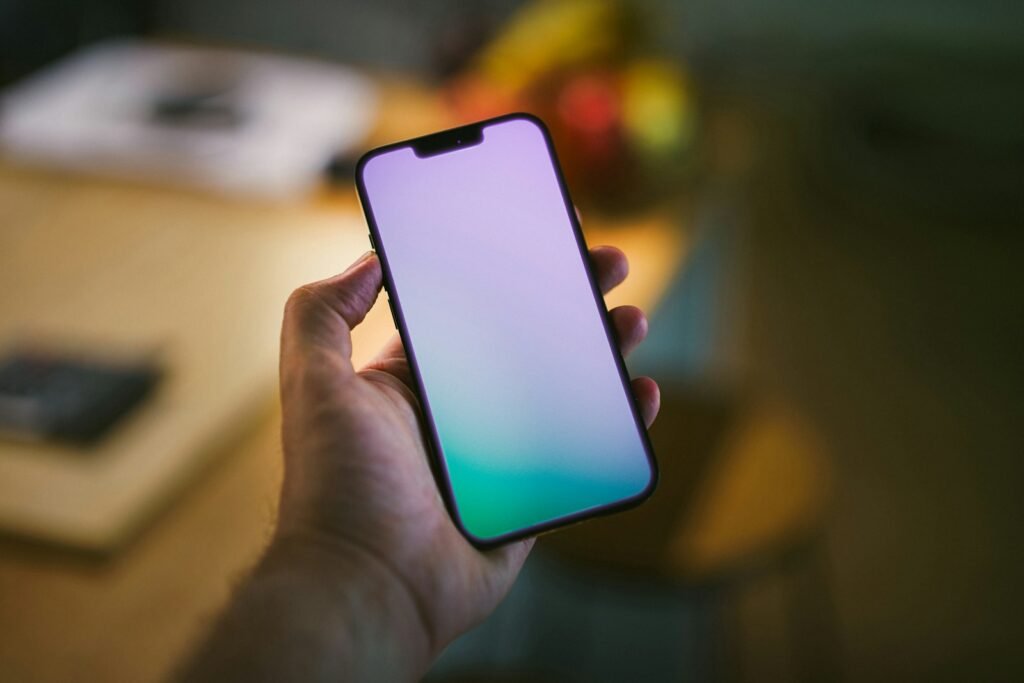 A person holding a cell phone in their hand